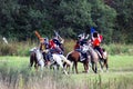 Soldiers fight on horses.