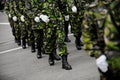 Soldiers in green camouflage marching