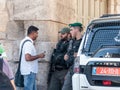 Soldiers guard the entrance to the old city of Jerusalem and talk with the local inhabitant in Jerusalem, Israel