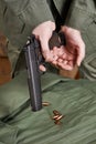 Soldiers load clip with cartridges into gun Colt