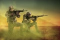 Soldiers with machine guns on battlefield. War conflict Royalty Free Stock Photo