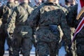 Soldiers march in parade step in full uniform. Rear view.