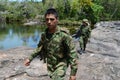 Soldiers patrol on the mountain river.