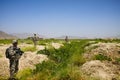 Soldiers patrol through old grape vineyard