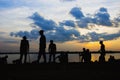 Soldiers rest on the river at sunset.