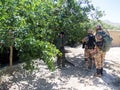 Soldiers searching the area around a village in Afghanistan