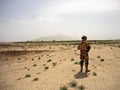 Soldiers searching the area around a village in Afghanistan