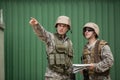 Soldiers showing direction to his colleague Royalty Free Stock Photo