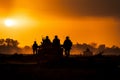 Soldiers silhouettes in the foggy sunset, surrounded by fire and smoke Royalty Free Stock Photo