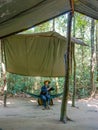 Soldiers sitting under a canopy. Installation of the American Vietnam war near the Cu Chi tun Royalty Free Stock Photo