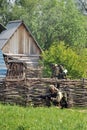 Soldiers of a special forces unit practice combat operations in a village at a military training ground