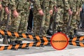 Soldiers stand in row with a guns in hand in camouflage uniforms with Quarantine sign. Epidemic virus 2019-nCoV Respiratory