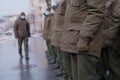 Soldiers of Ukrainian army are standing in the town uniform.