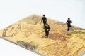 Soldiers walking on the country map, duty keeping the people and the country