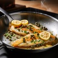 Sole MeuniÃ¨re being prepared in a frying pan with butter, capers, and lemon Royalty Free Stock Photo
