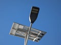 A sole solar street light during a clear sunny morning. Large solar panel mounted on top of the pole. Optical weather conditions