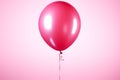 Solely suspended, a dark pink helium balloon showcases its vivid charm Royalty Free Stock Photo