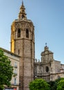 Solemn bell tower in sunlight and part of Cathedral facade in Valencia, Spain Royalty Free Stock Photo