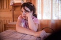 Solemn girl at table