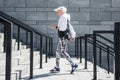 Solemn senior woman jogging outdoor on stone steps with handrails Royalty Free Stock Photo