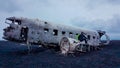 Iceland - Young man sitting on a crashed airplane