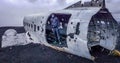 Iceland - Young man standing inside of a plane wreck