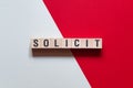 Solicit - word concept on cubes