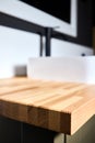 Solid ash glued timber under varnish edge corner table top selective focus macro closeup. Bathroom interior contemporary