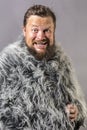 Solid bearded man in a fur mantle studio emotional Royalty Free Stock Photo
