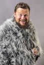 Solid bearded man in a fur mantle studio emotional Royalty Free Stock Photo