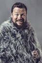 Solid bearded man in a fur mantle studio emotional Royalty Free Stock Photo