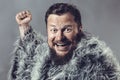 Solid bearded man in a fur mantle studio emotional Royalty Free Stock Photo