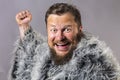 Solid bearded man in a fur mantle studio emotional Royalty Free Stock Photo
