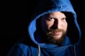 Solid bearded middle-aged man in a hood portrait