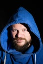 Solid bearded middle-aged man in a hood portrait