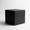 Solid Black Cube Centered on Light Grey Gradient Background in Studio Lighting Royalty Free Stock Photo