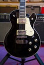 Solid black electric guitar Les Paul-style