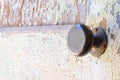 Solid brass doorknob and peeling paint door