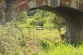 Solid brickwork of a bridge across a stream