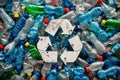 Solid carpet of plastic bottles with a white recycling symbol