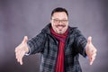 Solid cheerful man in coat and kerchief standing welcome