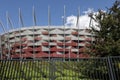 A solid fence surrounds the stadium in Warsaw