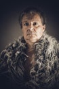 Solid middle-aged man in a fur mantle Royalty Free Stock Photo