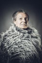 Solid middle-aged man in a fur mantle Royalty Free Stock Photo