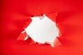 Solid red background with white backdrop ripped hole in the center Royalty Free Stock Photo