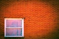 A solid red brick wall with a single glass-paned window in Orwell, Ohio Royalty Free Stock Photo