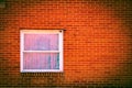 A solid red brick wall with a single glass-paned window in Orwell, Ohio Royalty Free Stock Photo