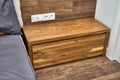 Solid wood nightstand in the interior. Solid elm nightstand. Details furniture