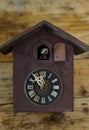 antique cuckoo wall clock on wood background ,time concept