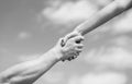 Solidarity, compassion, and charity, rescue. Hands of man and woman reaching to each other, support. Giving a helping Royalty Free Stock Photo